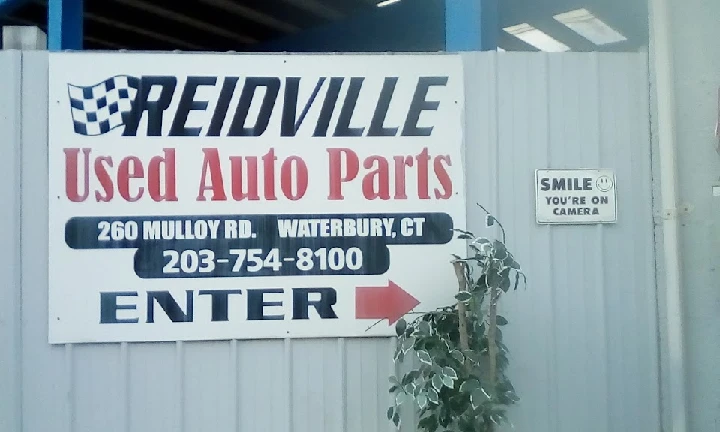 Reidville Used Auto Parts sign with contact info.