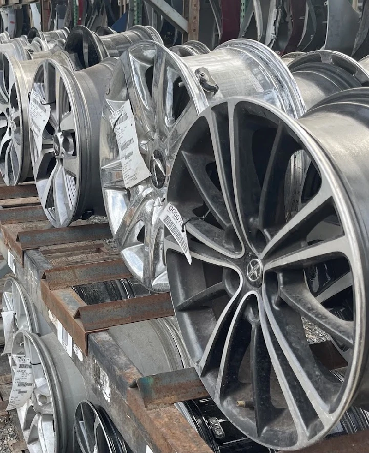 Rims displayed on racks at All Auto Parts.