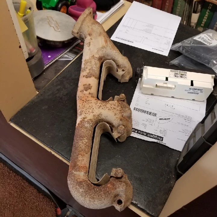 Rusty automotive part on a workbench at Doggett Auto Parts.