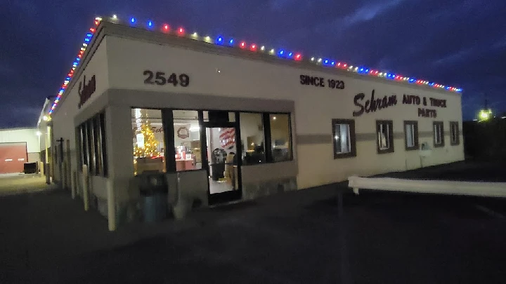 Schram Auto Parts building exterior at night.