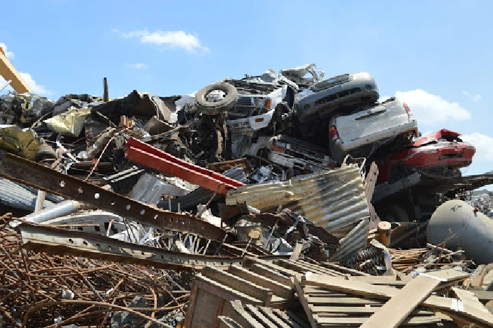 Scrap metal and wrecked cars piled high.