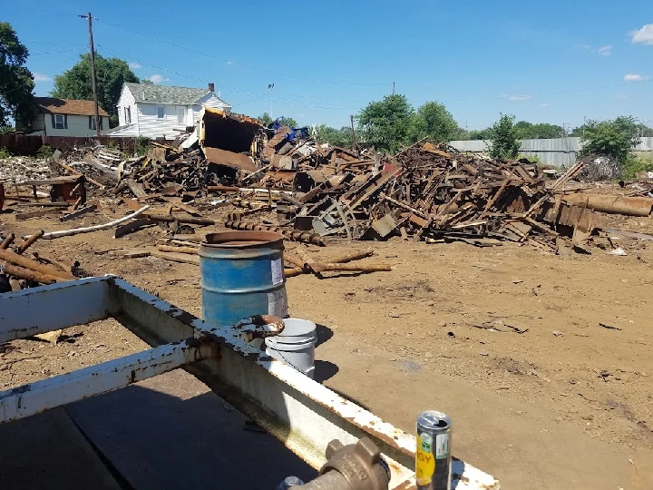 Scrap metal yard with piles of discarded materials.