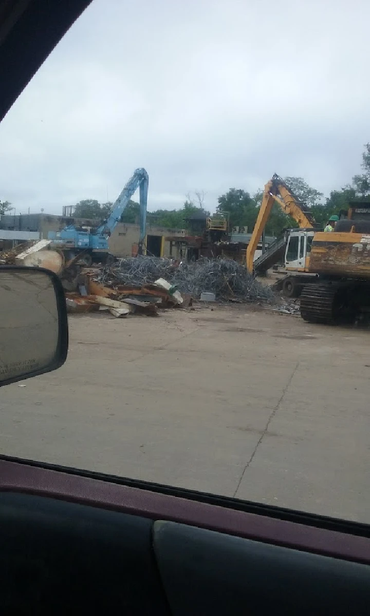 Scrap yard with machinery processing metal debris.