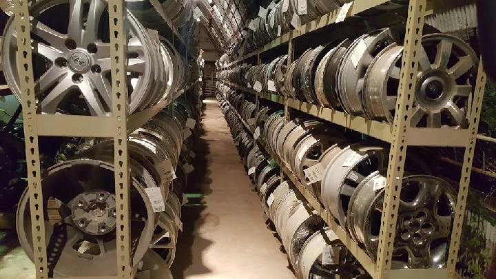 Shelves lined with various auto wheel rims.