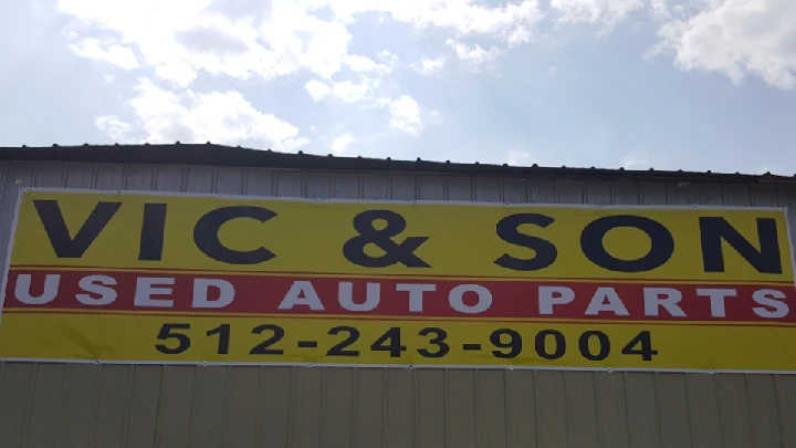 Sign for Vic & Son Used Auto Parts, contact info included.