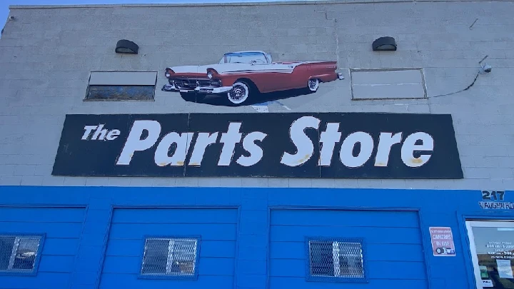 Signage for The Parts Store with vintage car graphic.