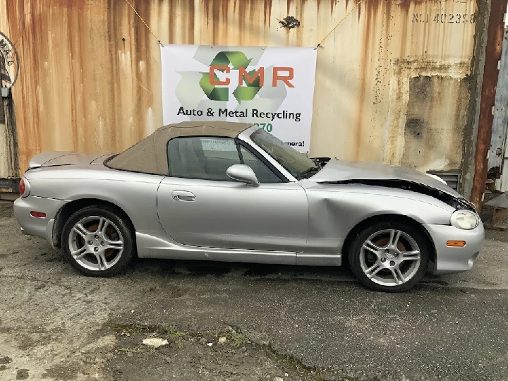 Silver convertible car at CMR Auto Recycling.