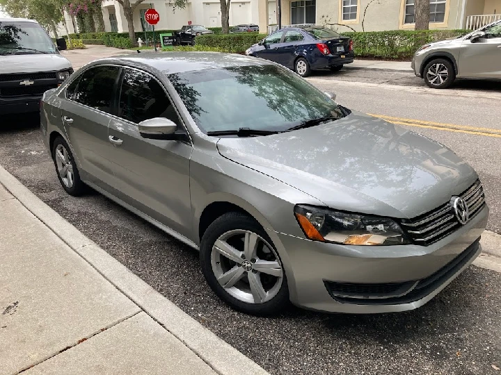 Silver Volkswagen parked on a city street.