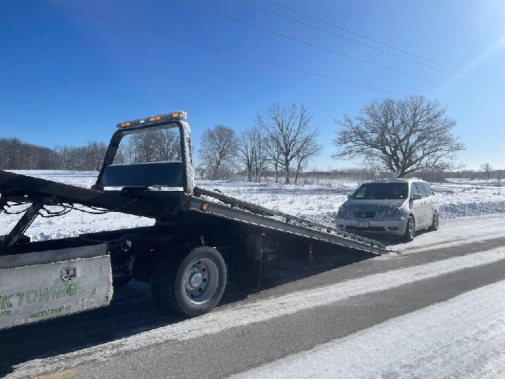 Snowy roadside towing service in action.