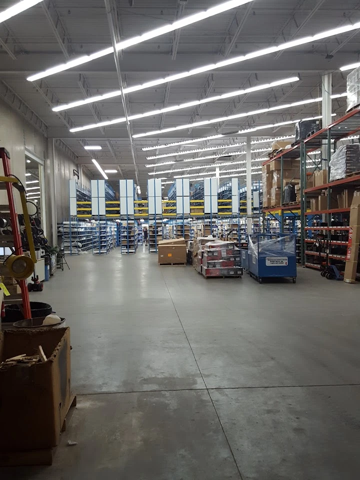 Spacious warehouse with shelves and pallets.