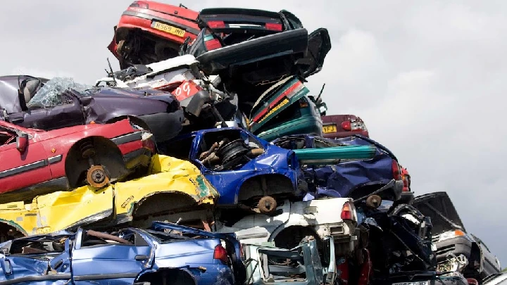 Stacked abandoned cars in a junkyard.