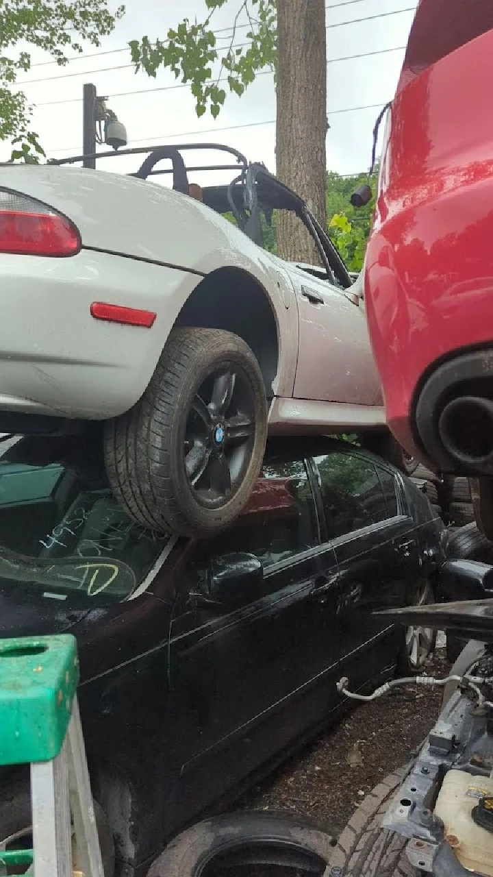 Stacked cars at Reidville Used Auto Parts yard.