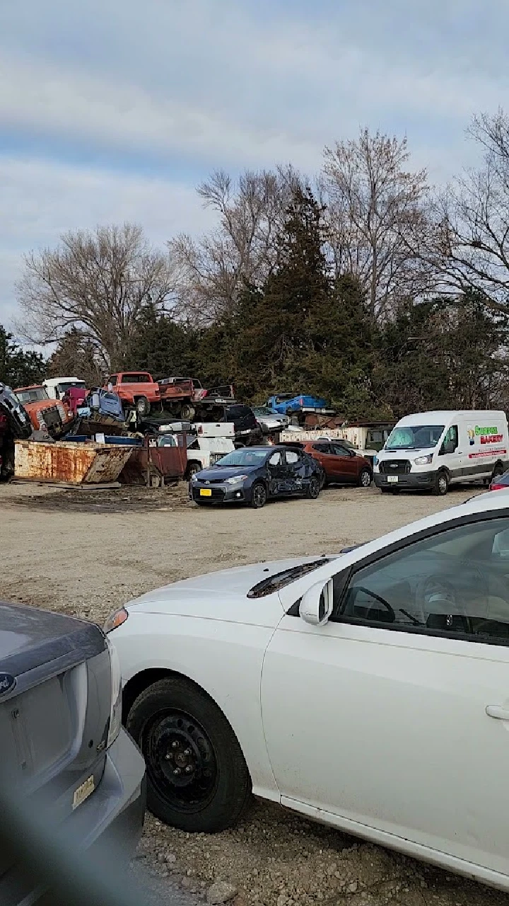 Stacked cars and scrap metal at Stapleton Salvage.