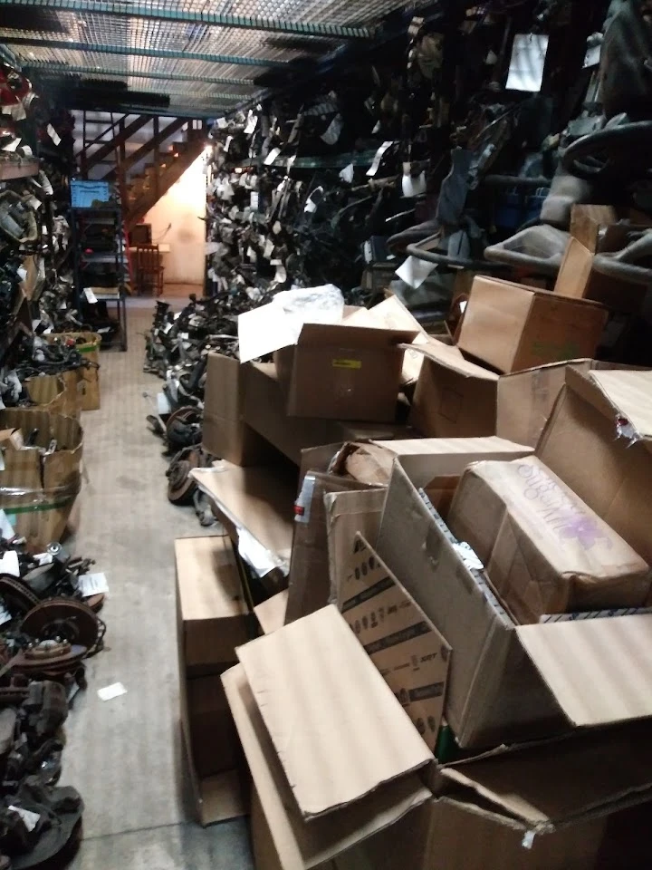 Storage area filled with boxes and auto parts.