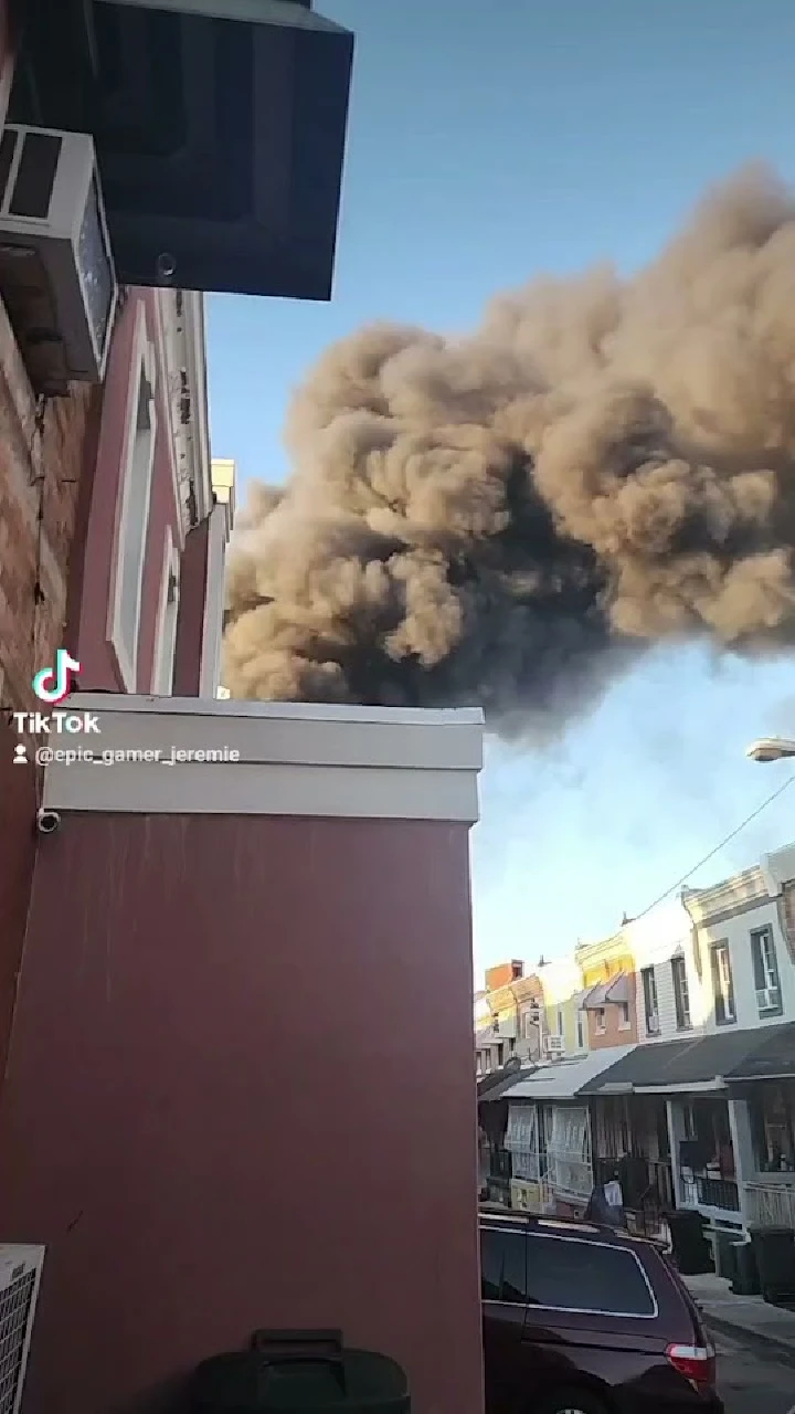 Thick smoke billowing over city buildings.