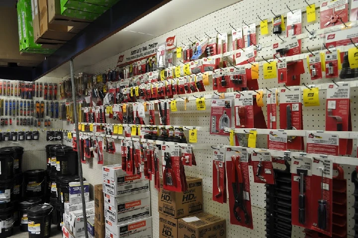 Tool display wall with various hand tools and accessories.