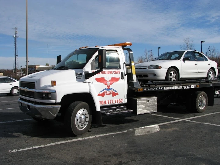 Tow truck with junk car for Sam Auto Salvage.