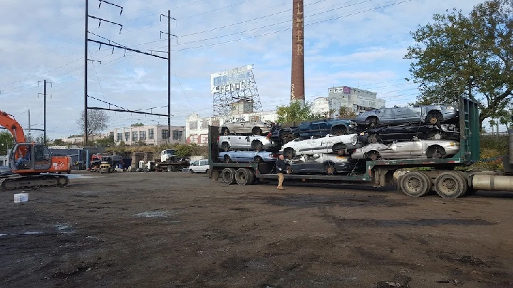 Towed vehicles stacked on a flatbed truck.