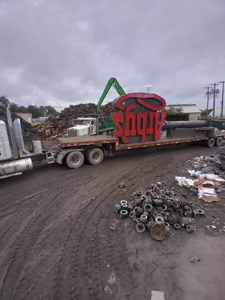 Truck loaded with metal scraps at a recycling site.