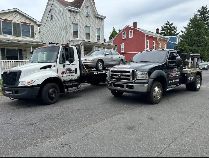 Two tow trucks from Valentino's Auto Recycling.