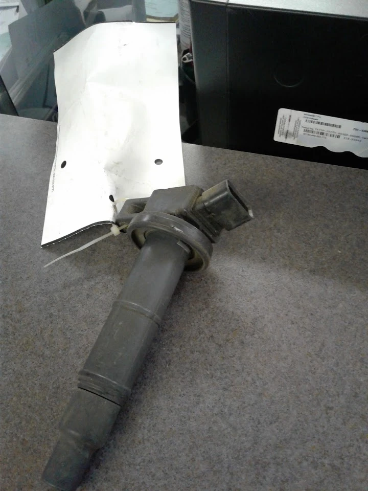 Used auto part: ignition coil on a counter.