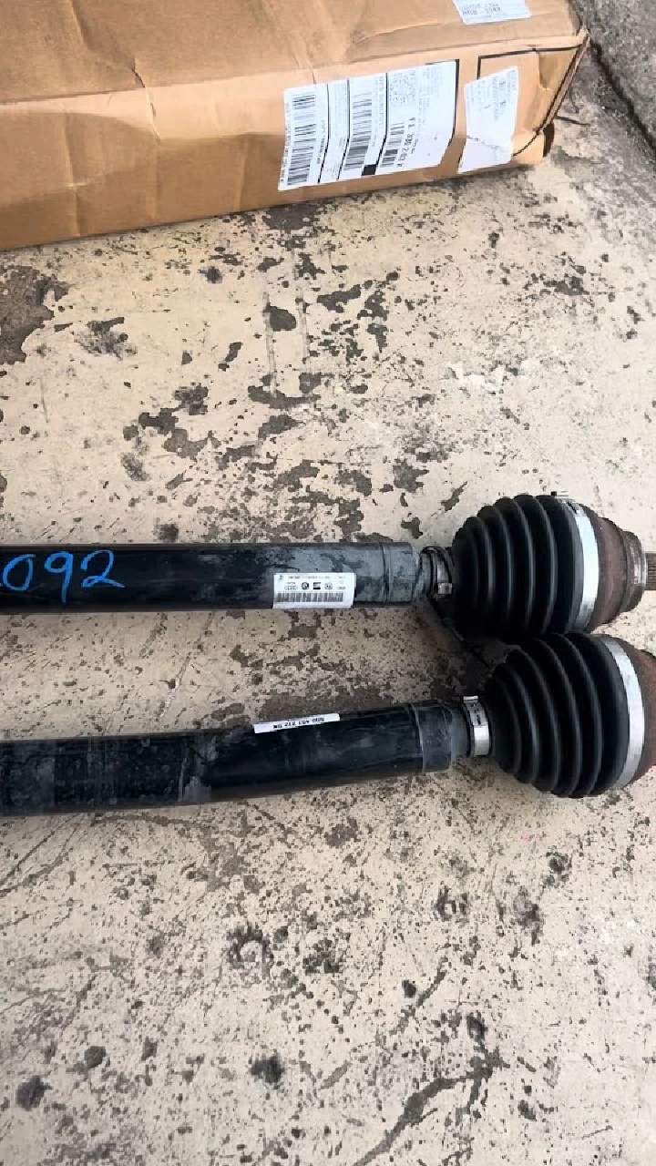 Used auto parts: axles with protective boots.