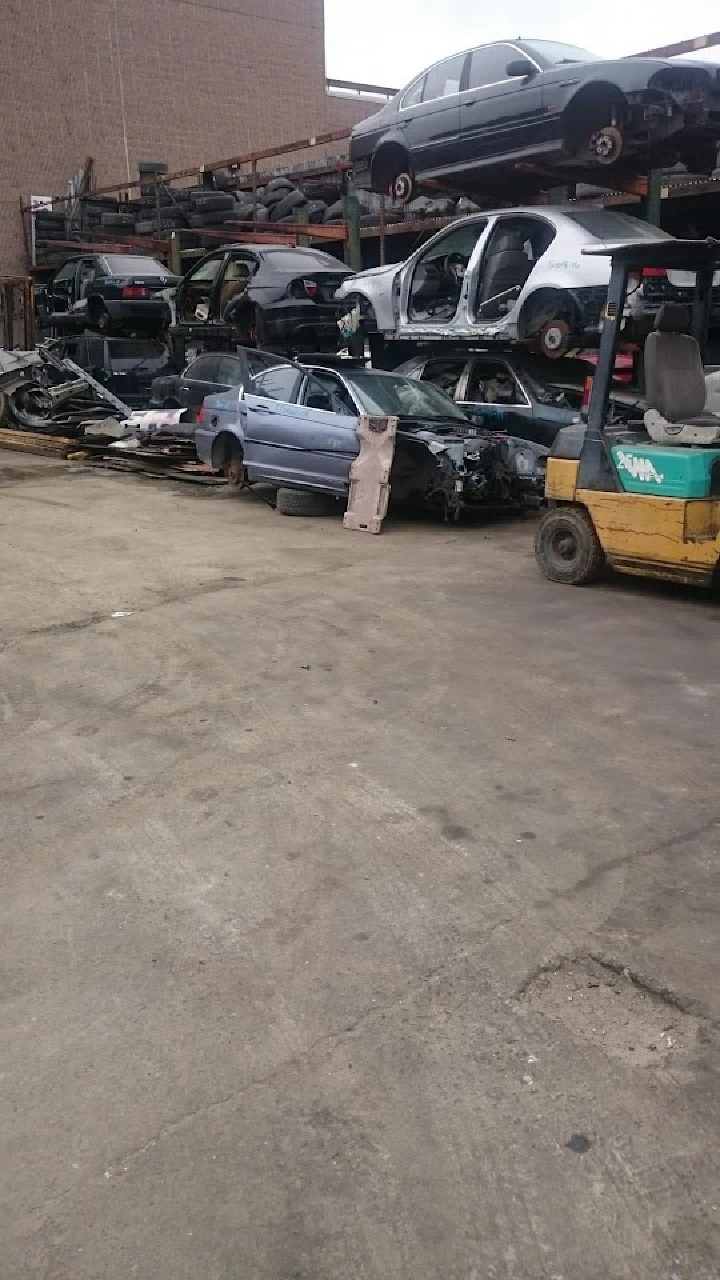 Used cars stacked in an auto parts yard.