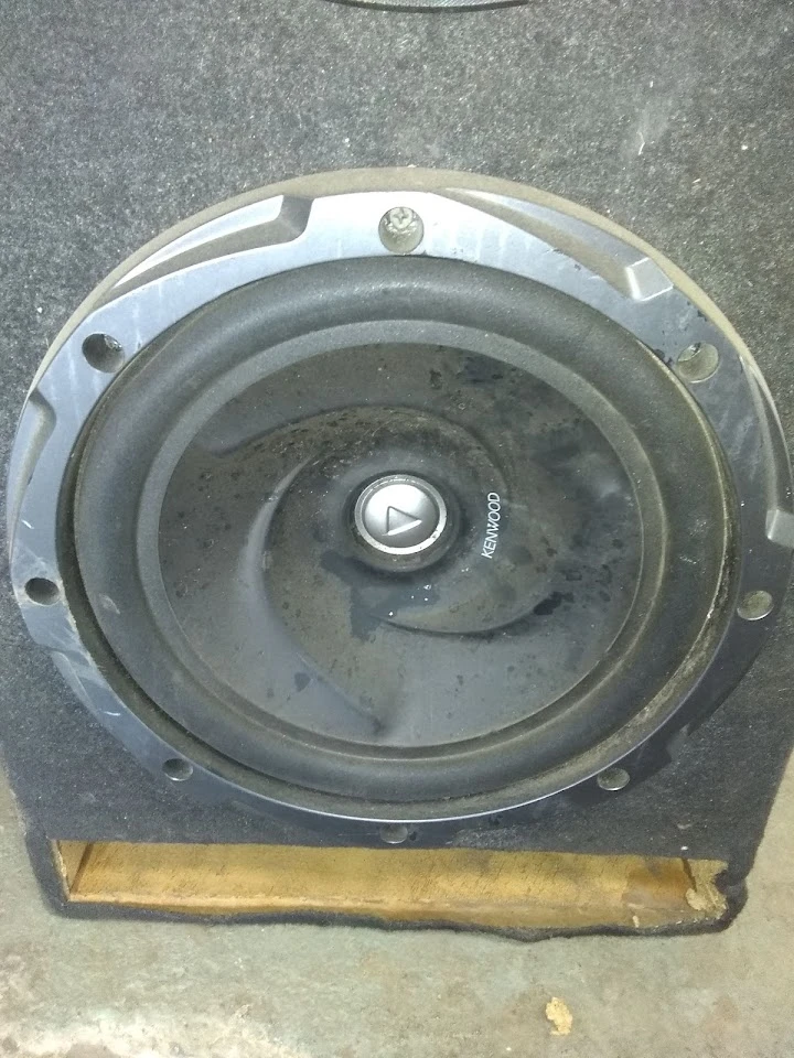 Used Kenwood speaker in a scrap yard setting.