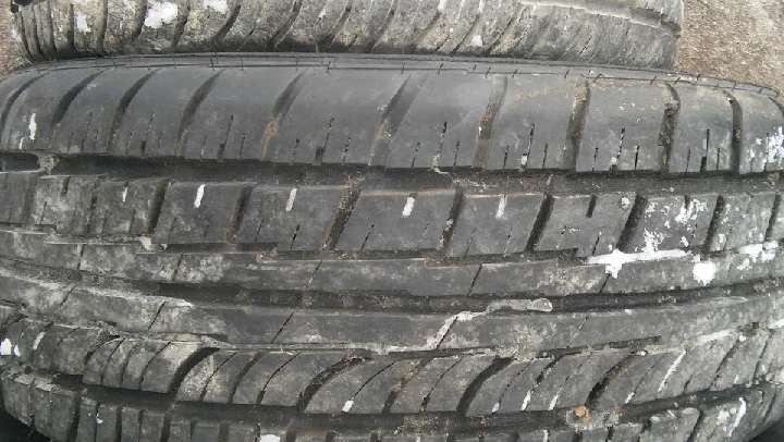 Used tires stacked vertically, showing tread patterns.