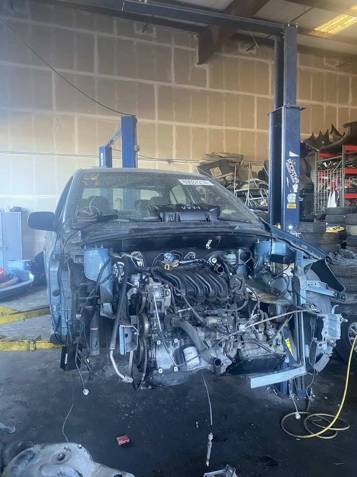 Vehicle engine being serviced at HTP Auto Recycling.