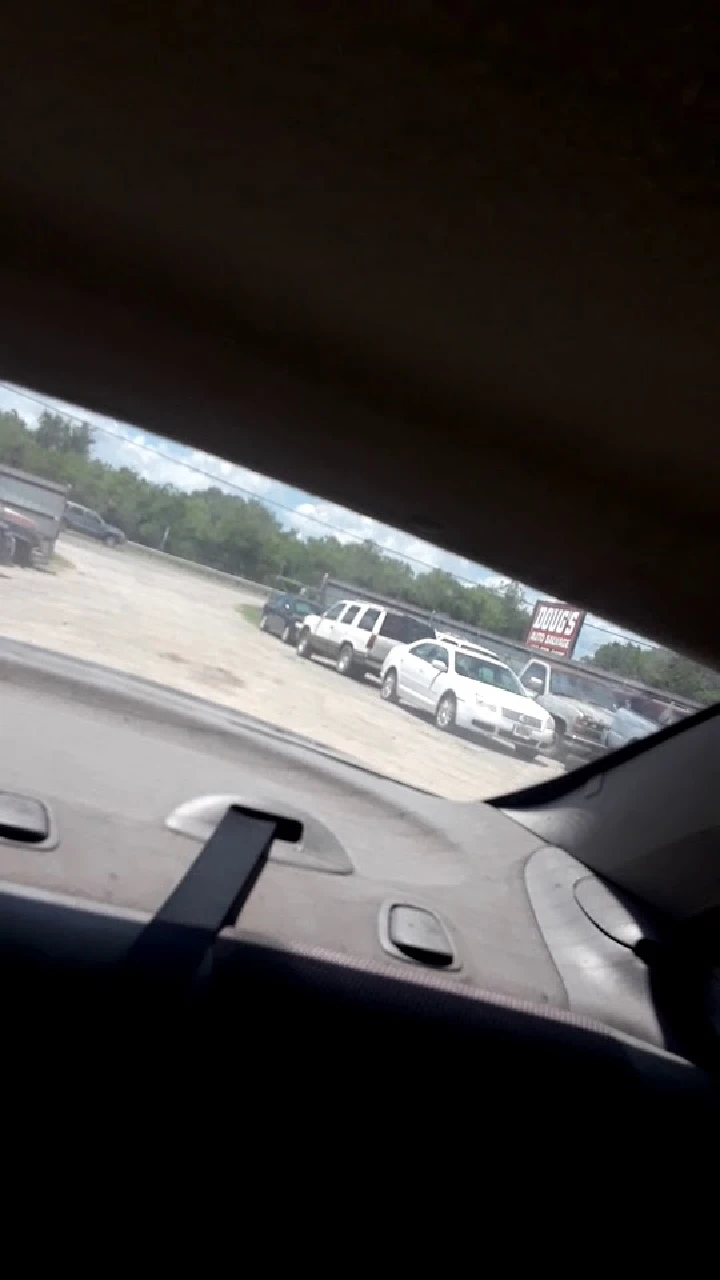 View of Doug's Auto Salvage lot from a car.