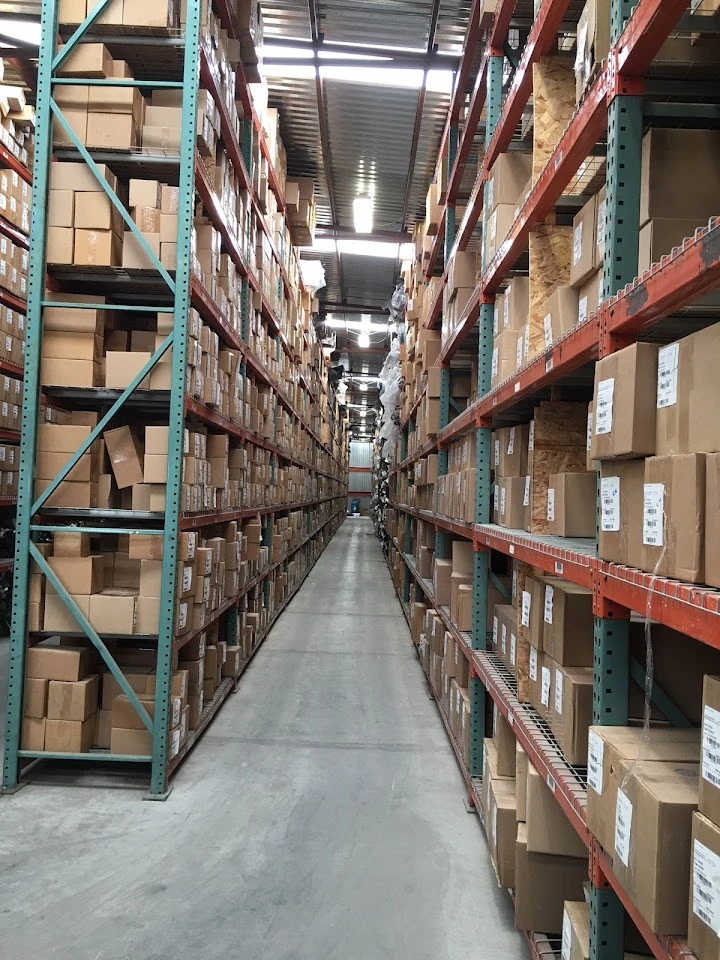 Warehouse with tall shelves of stacked boxes.