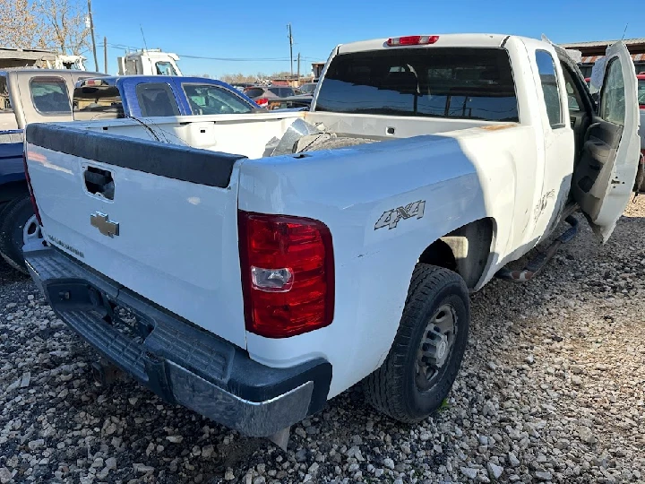 White pickup truck at salvage yard.