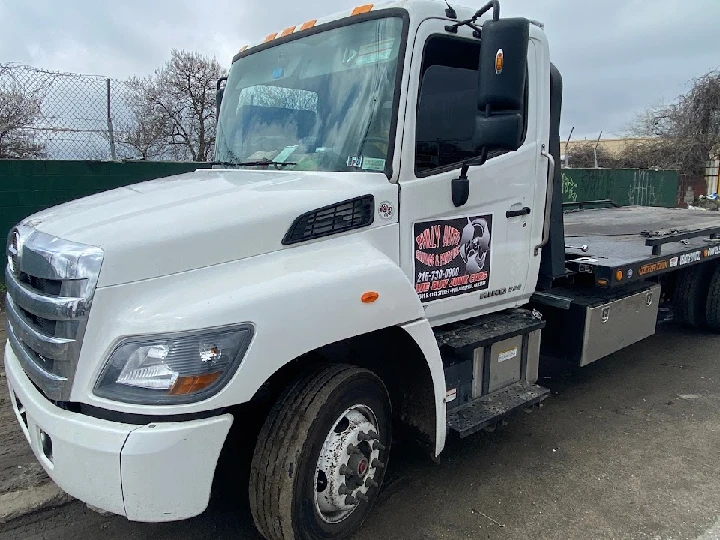 White tow truck with Philly Auto Salvage logo.