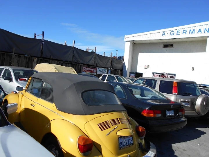 A-German Auto parts & service parking lot with cars.