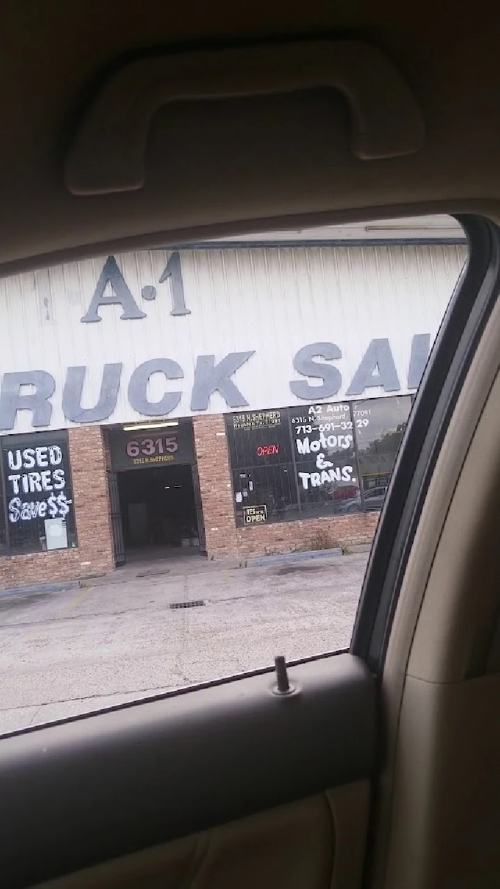 A view of a truck sale shop with signage.