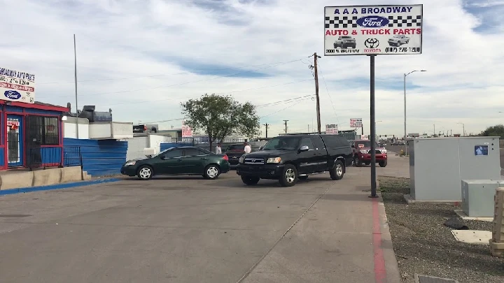 AAA Broadway Auto Parts storefront with vehicles.