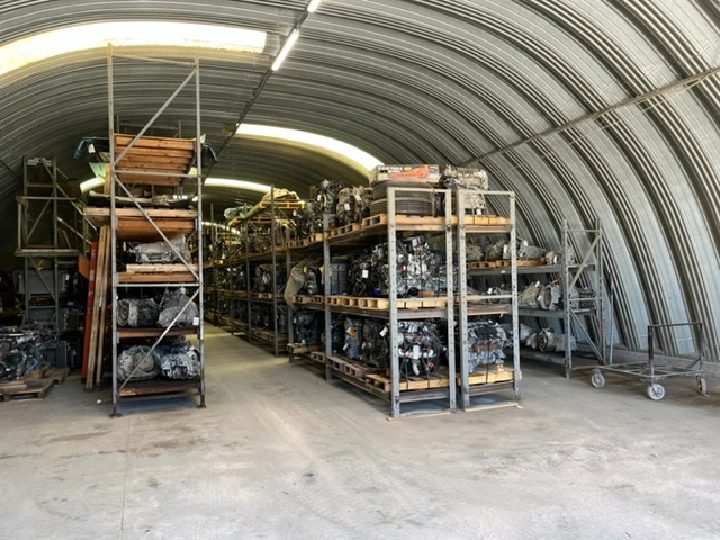 Auto parts storage with shelved engines and equipment.