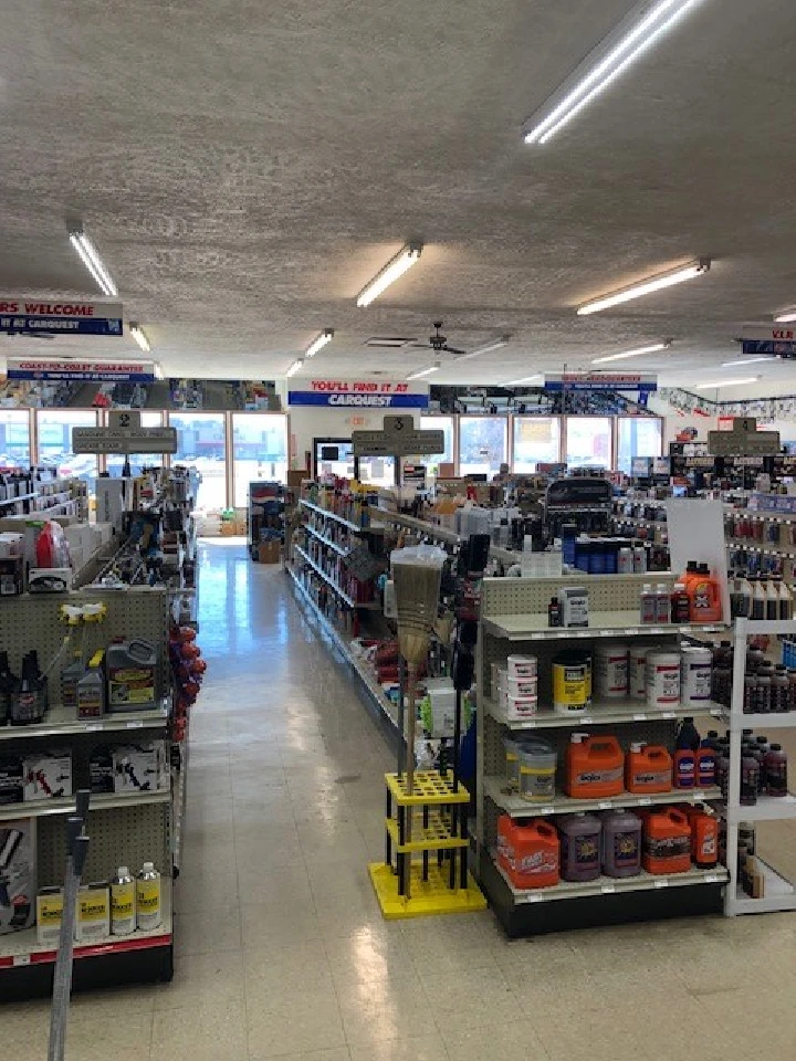 Auto parts store aisle filled with various products.