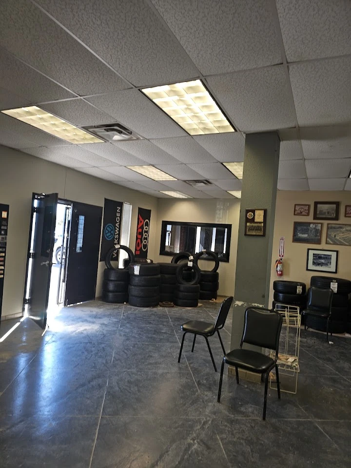 Auto parts store interior with tires and seating.