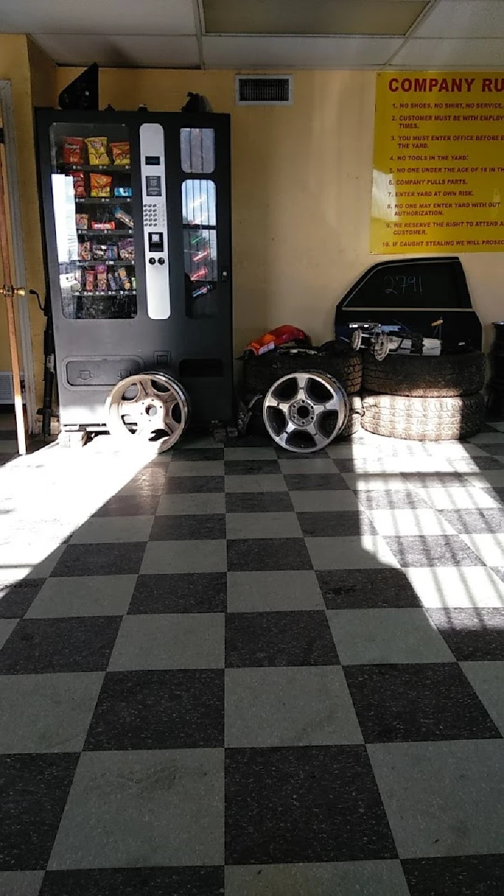 Auto parts store interior with wheels and vending machine.