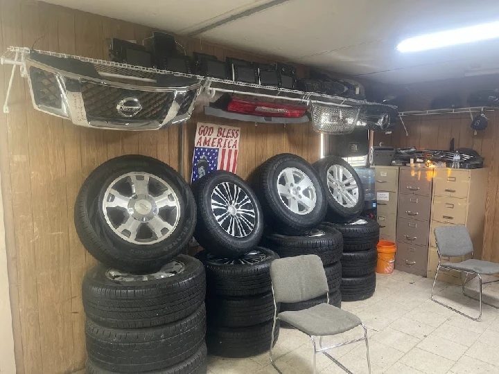 Auto parts and tires stored in a workshop.