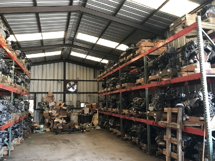 Auto parts warehouse with engine storage shelves.