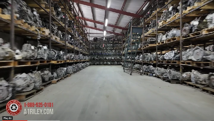 Auto parts warehouse with shelves of engines.