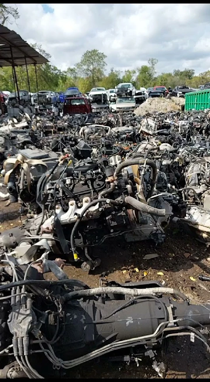 Auto parts yard filled with discarded car engines.