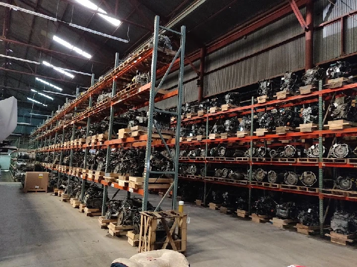 Auto salvage yard with stacked engines on shelves.