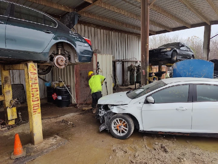 Automotive salvage yard with dismantled vehicles.