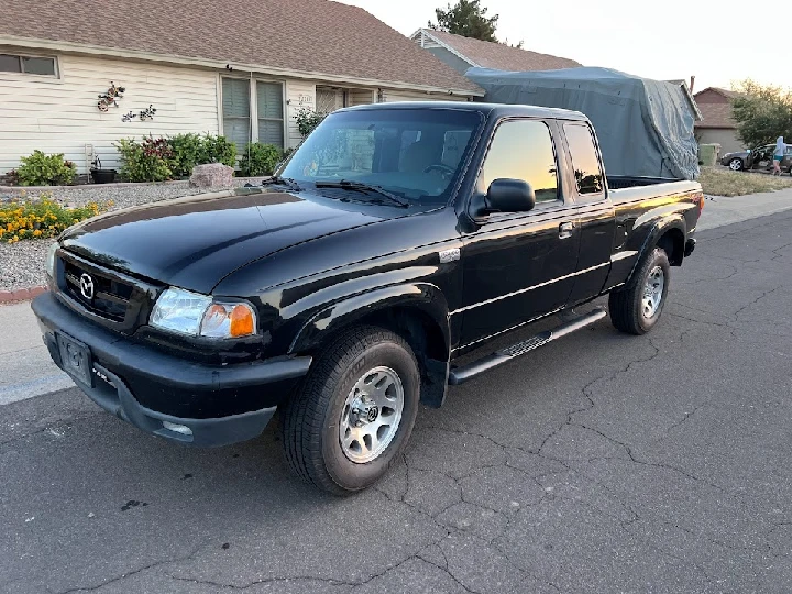 Black truck parked on a residential street.