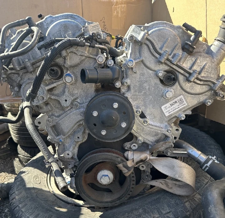 Engine component on tires, background cardboard boxes.