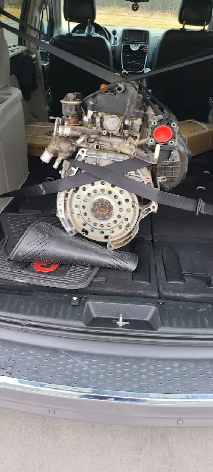 Engine secured in the back of a vehicle.